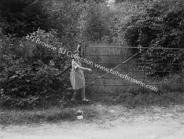 GIRL SWINGING ON GATE